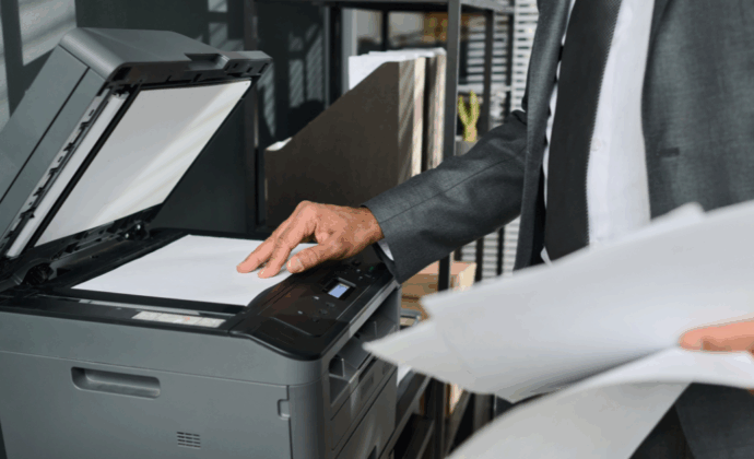 A man manually making copies of a document