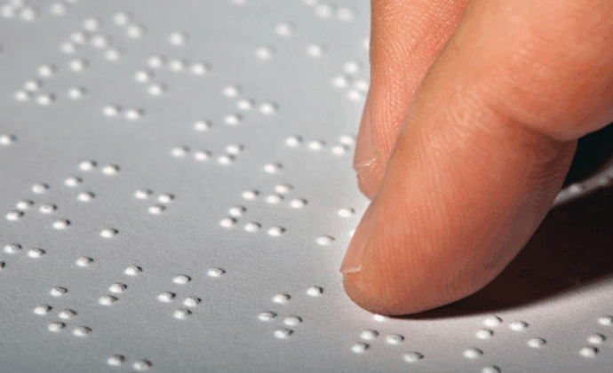 Person's finger tracing braille language