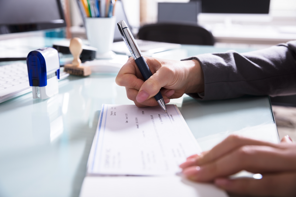 a woman signing some paperwork