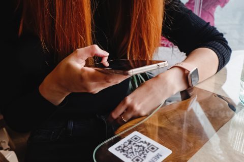 woman scanning a qr code using her mobile device