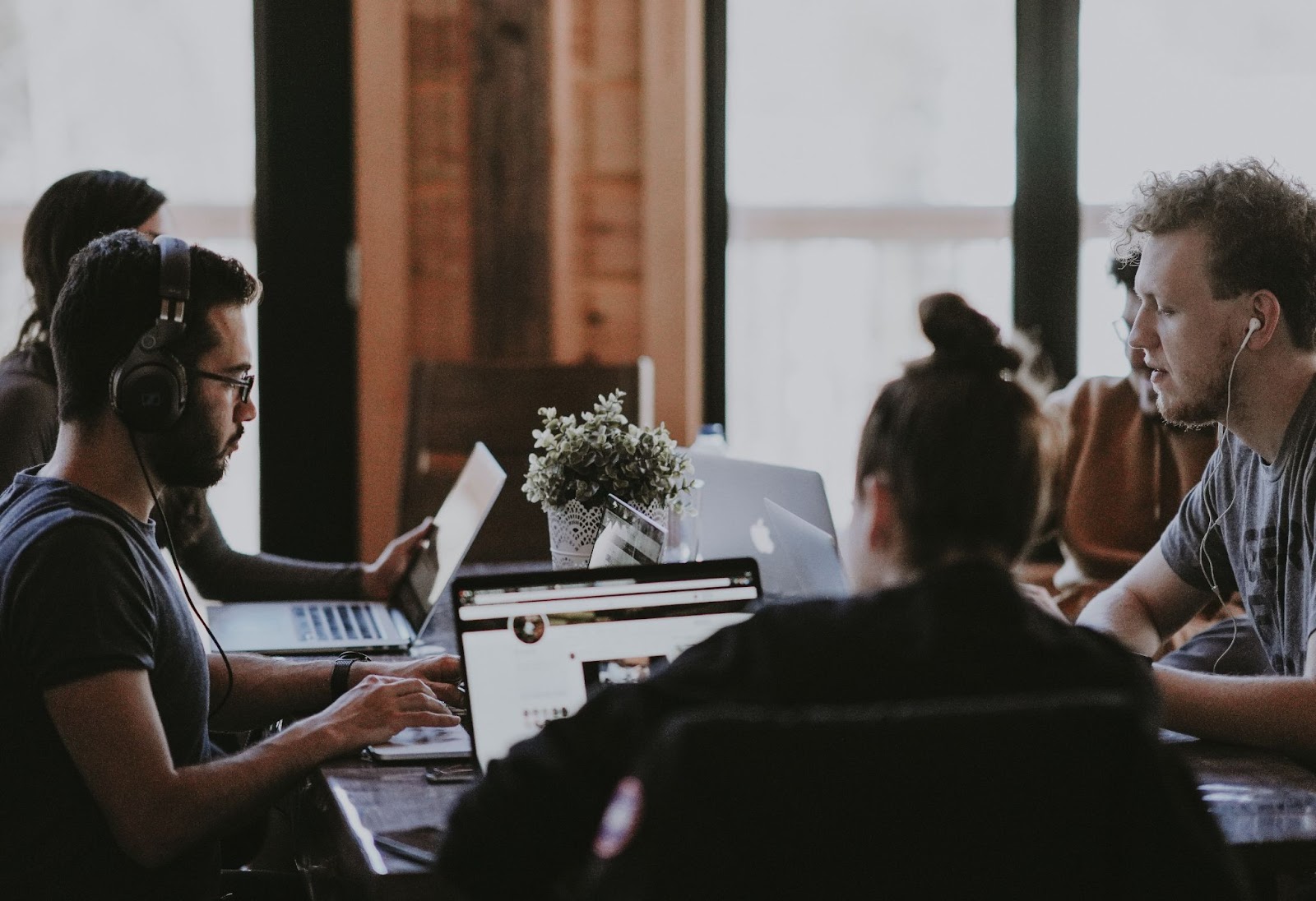 group of colleagues working on laptops in a co-working space