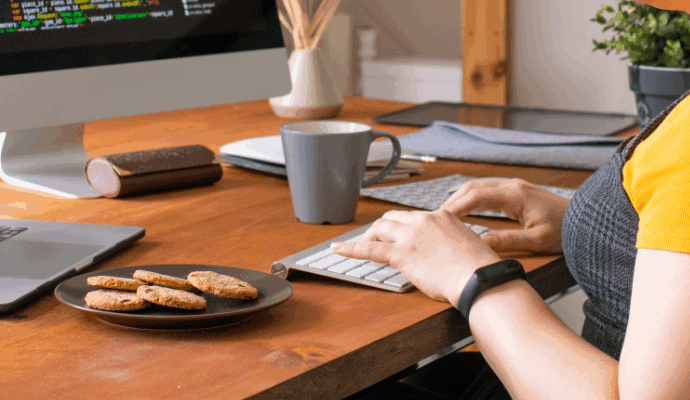 Woman working at desk from home using hybrid mail